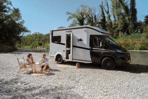 Laika Kosmo L105 on stone pitch with 2 campers in front on chairs